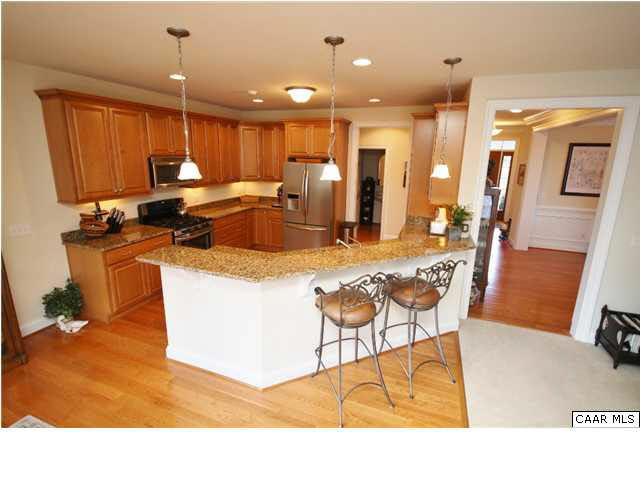 79 Ridgeview Drive Ruckersville, VA 22968 - Photo 11 of 29 a living room with stainless steel appliances kitchen island granite countertop a sink a stove and a refrigerator