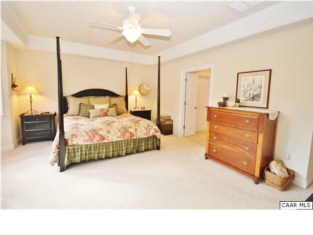 79 Ridgeview Drive Ruckersville, VA 22968 - Photo 16 of 29 a bedroom with a bed and a chandelier