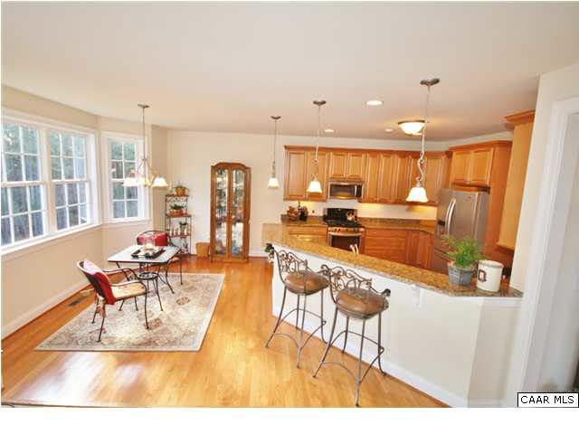 79 Ridgeview Drive Ruckersville, VA 22968 - Photo 9 of 29 a living room with stainless steel appliances furniture a rug and a kitchen view