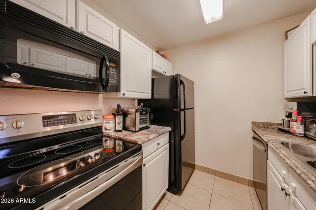 a kitchen with stainless steel appliances and chandelier