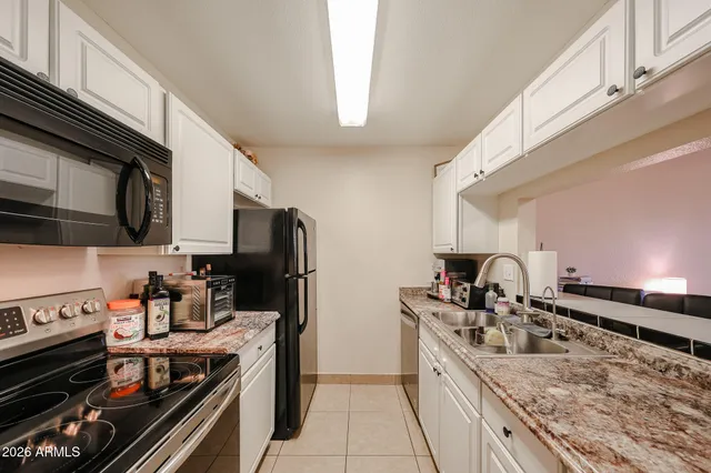 a kitchen with a sink stove and refrigerator