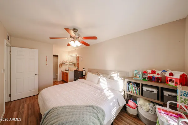 a bedroom with a bed and a chandelier