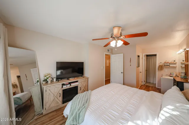 a bedroom with a bed and a flat screen tv