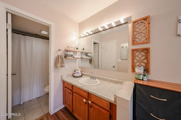 a bathroom with a sink a mirror and a shower