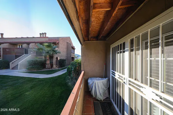a view of a house with backyard and porch