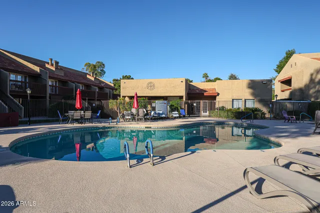 a living room with furniture a flat screen tv and a floor to ceiling window