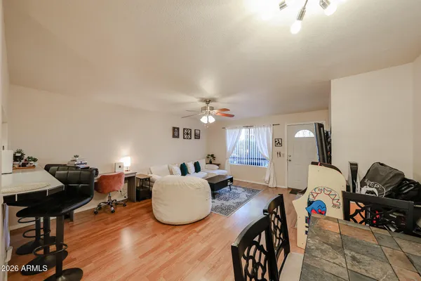 a living room with furniture and a wooden floor