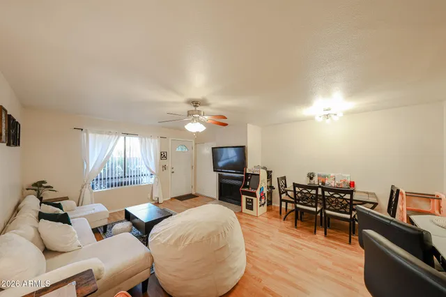 a living room with furniture a fireplace and a flat screen tv