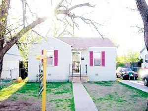 4618 South Travis Street Amarillo, TX 79110 - Photo 1 of 1 a front view of a house with a yard and garage