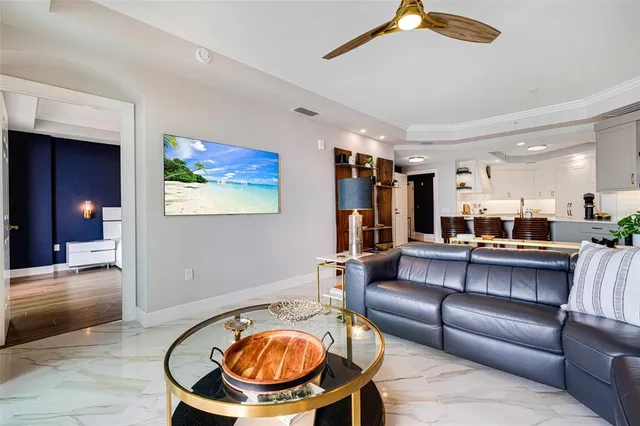 a living room with furniture and a chandelier