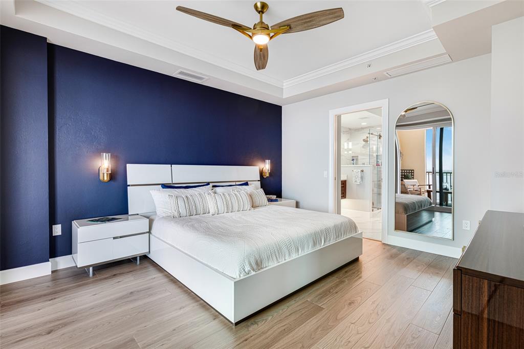 2745 First Street, Unit 1402 Fort Myers, FL 33916 - Photo 13 of 43 a bedroom with a bed and a chandelier