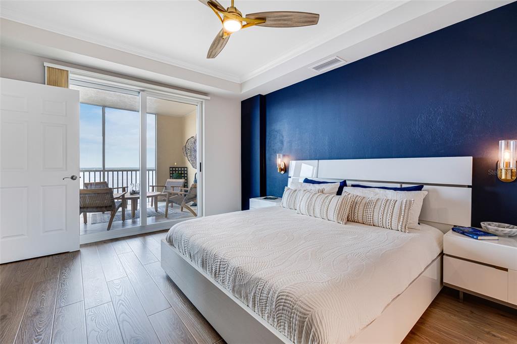 2745 First Street, Unit 1402 Fort Myers, FL 33916 - Photo 14 of 43 a large bedroom with bed and a chandelier