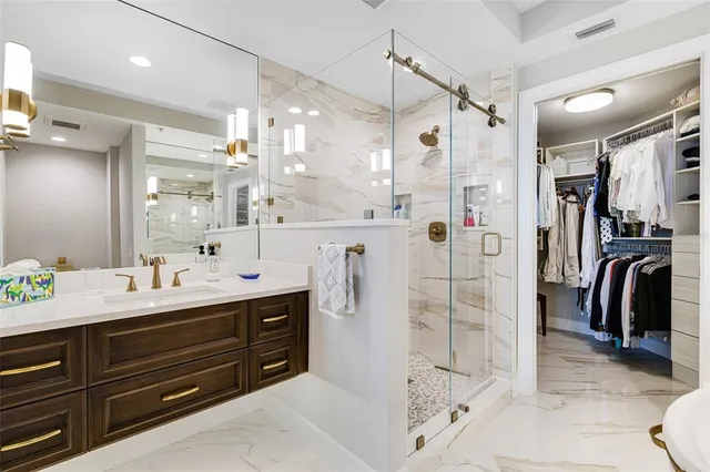 a bathroom with a double vanity sink mirror and shower