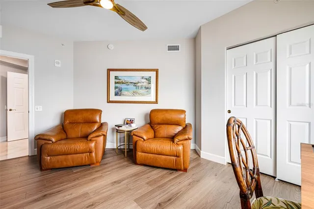 a living room with furniture and a mirror