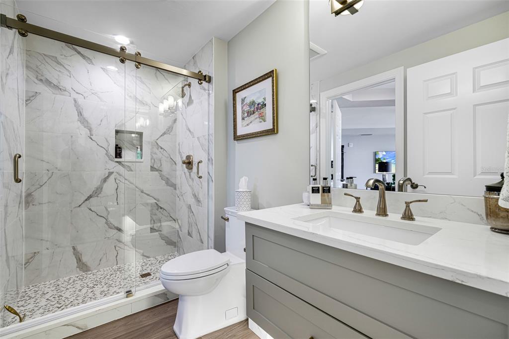 2745 First Street, Unit 1402 Fort Myers, FL 33916 - Photo 26 of 43 a bathroom with a sink a toilet and shower