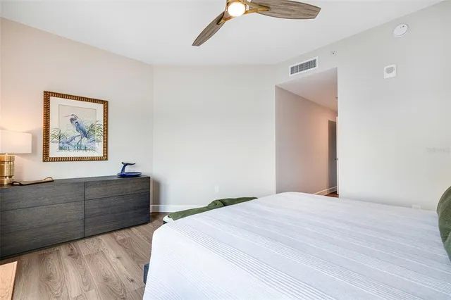 a bedroom with a bed and a painting on the wall