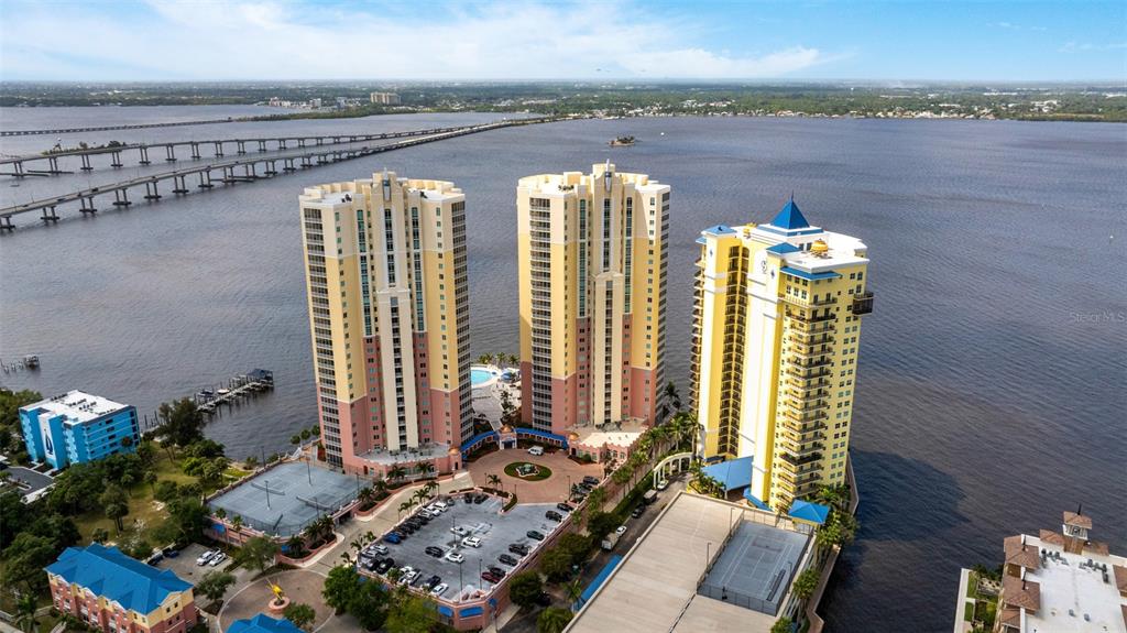 2745 First Street, Unit 1402 Fort Myers, FL 33916 - Photo 36 of 43 a view of a balcony with two chairs and a potted plant