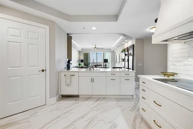 a room with white cabinets and sink