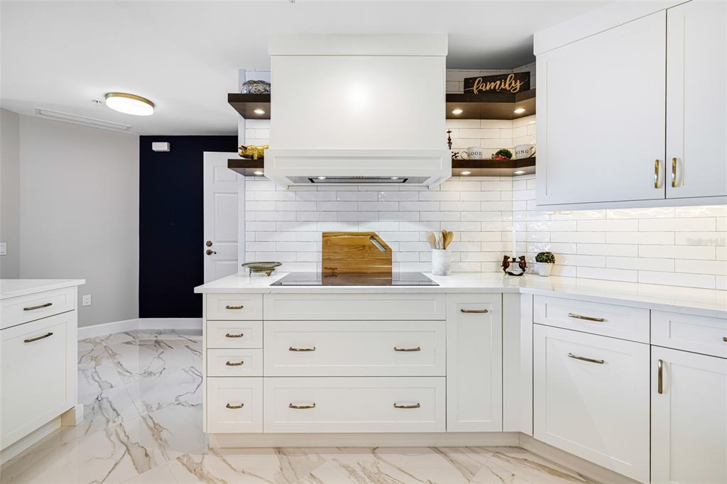 2745 First Street, Unit 1402 Fort Myers, FL 33916 - Photo 6 of 43 a kitchen with a stove and cabinets