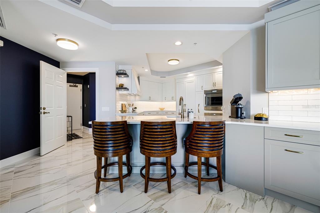 2745 First Street, Unit 1402 Fort Myers, FL 33916 - Photo 8 of 43 a kitchen with a table and chairs in it
