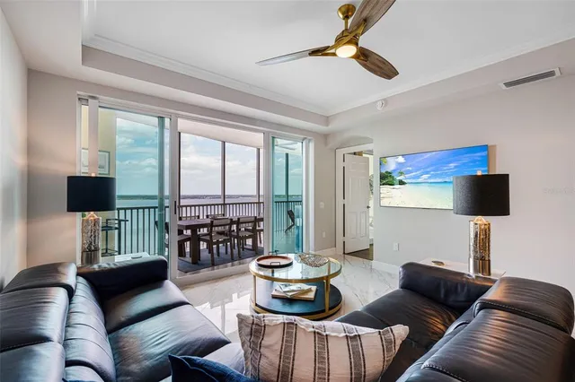a living room with furniture and a floor to ceiling window