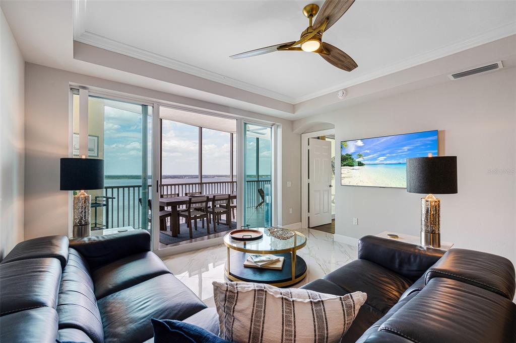2745 First Street, Unit 1402 Fort Myers, FL 33916 - Photo 10 of 43 a living room with furniture and a floor to ceiling window