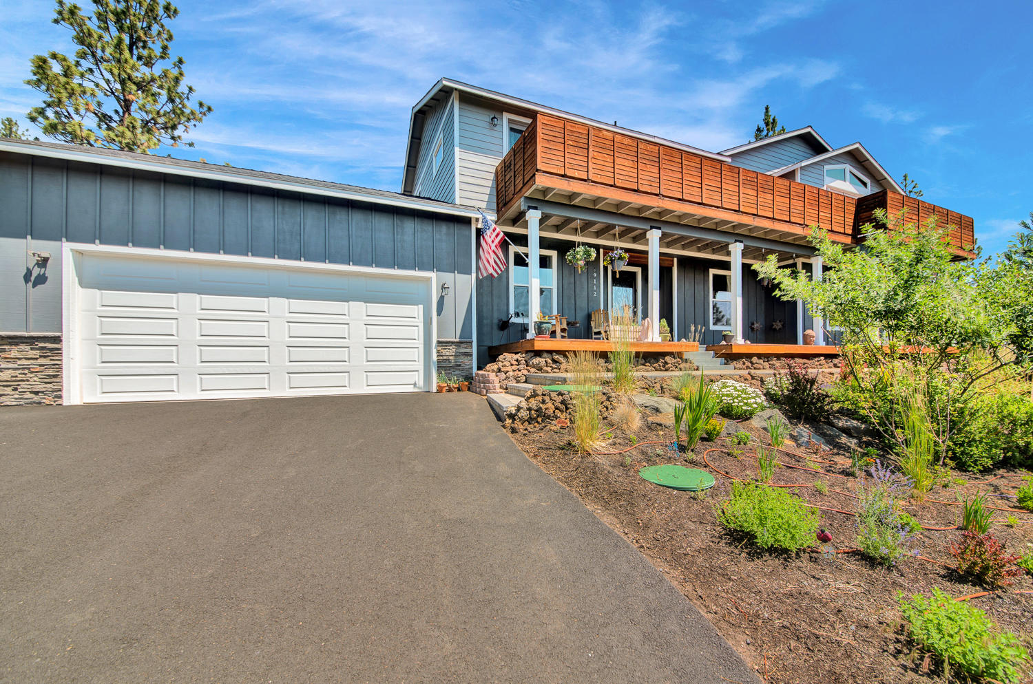 19112 Pumice Butte Road Bend, OR 97702 - Photo 36 of 36 a front view of a house with a garden and plants