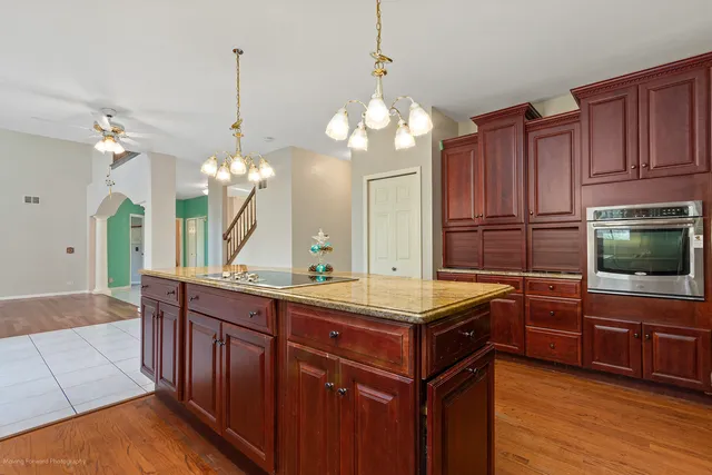 a view of a livingroom with wooden floor and a fireplace