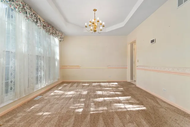 a spacious bathroom with a double vanity sink a large mirror and a bathtub