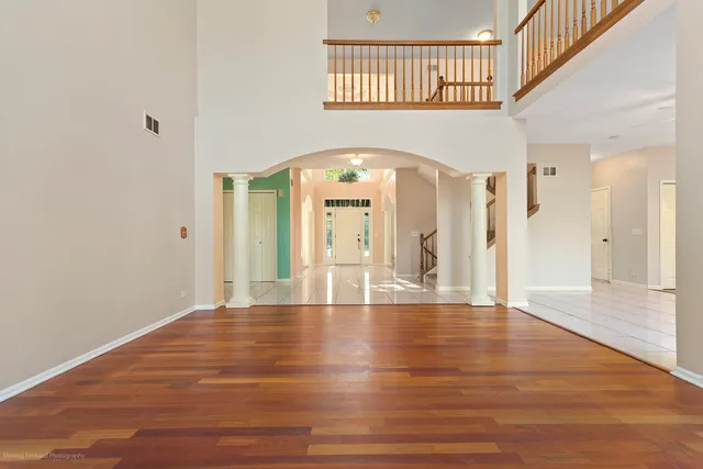 a view of an entryway with a chandelier fan and windows
