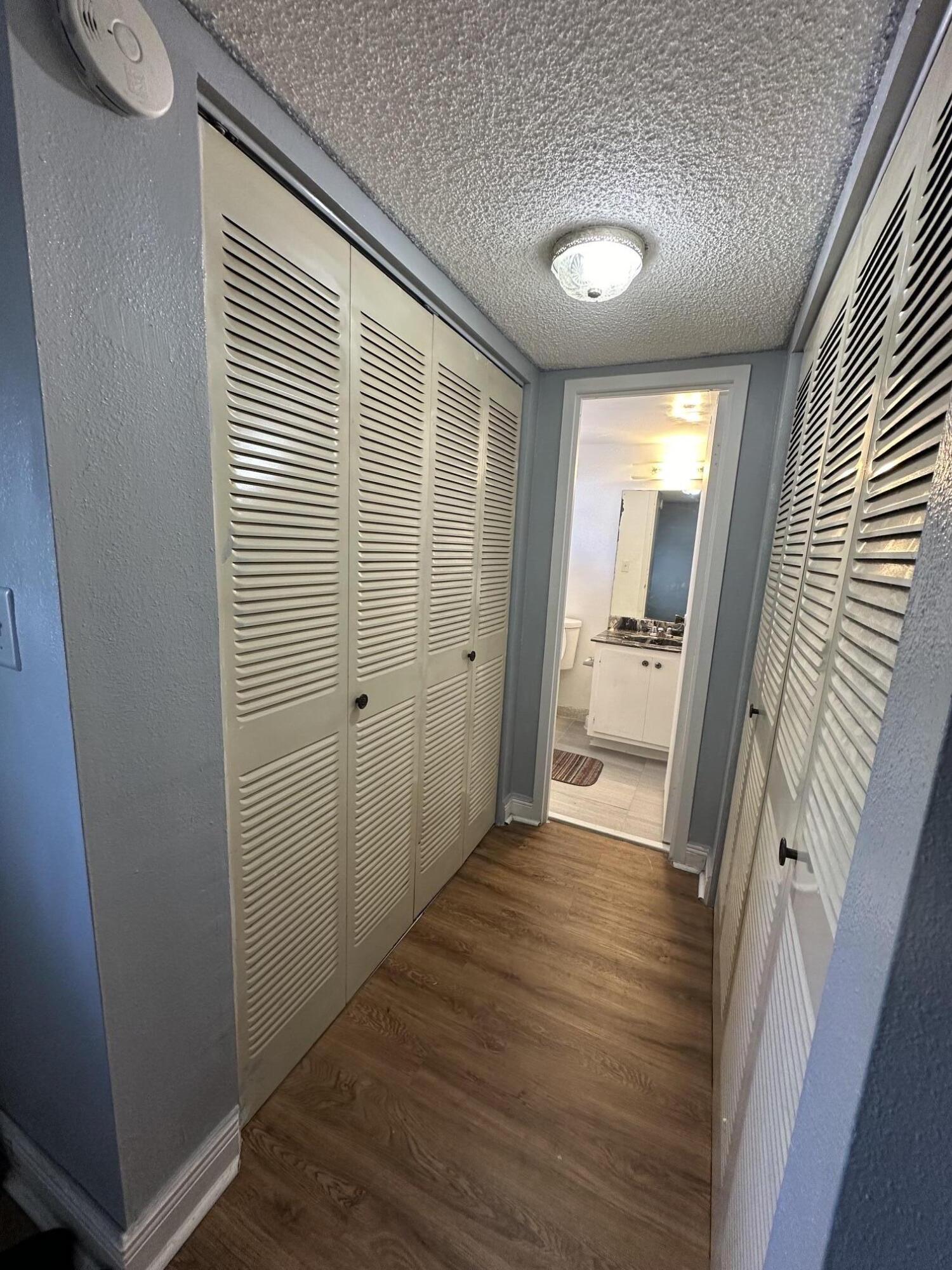 8341 Sands Point Boulevard, Unit B206 Tamarac, FL 33321 - Photo 6 of 11 a view of a hallway with wooden floor and a bathroom
