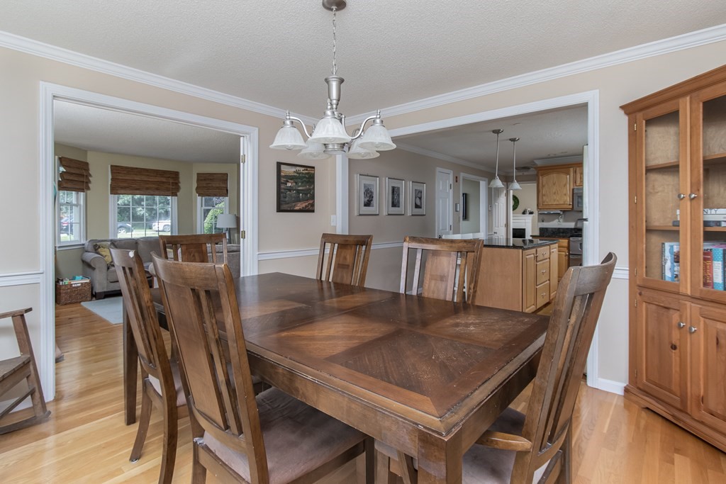 19 Hammond Farm Road Haverhill, MA 01832 - Photo 11 of 42 a view of a dining room with furniture a chandelier and wooden floor