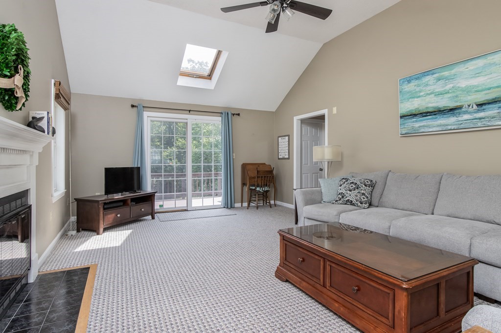 19 Hammond Farm Road Haverhill, MA 01832 - Photo 20 of 42 a living room with furniture a flat screen tv and a fireplace