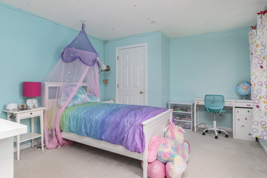 19 Hammond Farm Road Haverhill, MA 01832 - Photo 24 of 42 a bedroom with a bed and a chandelier