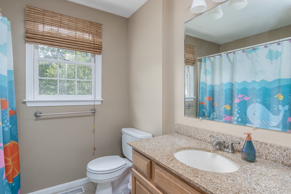 19 Hammond Farm Road Haverhill, MA 01832 - Photo 26 of 42 a bathroom with a granite countertop toilet a sink a mirror and a window
