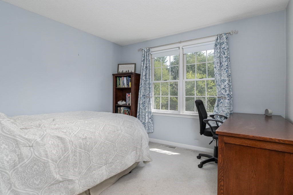 19 Hammond Farm Road Haverhill, MA 01832 - Photo 27 of 42 a bedroom with a bed and a desk next to a window