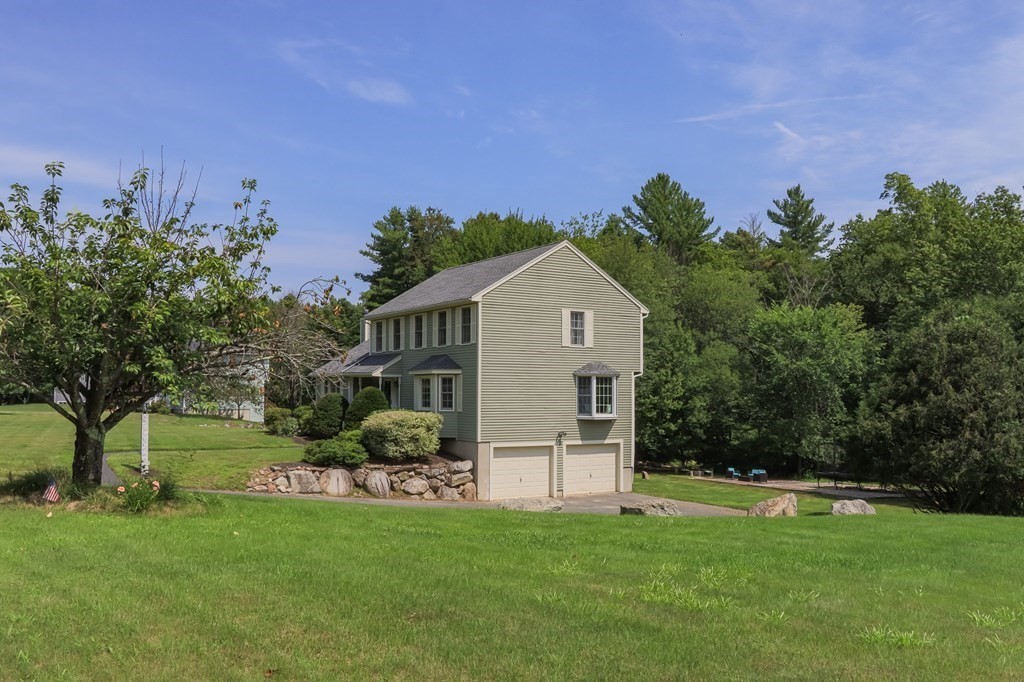 19 Hammond Farm Road Haverhill, MA 01832 - Photo 5 of 42 a front view of a house with a garden and trees