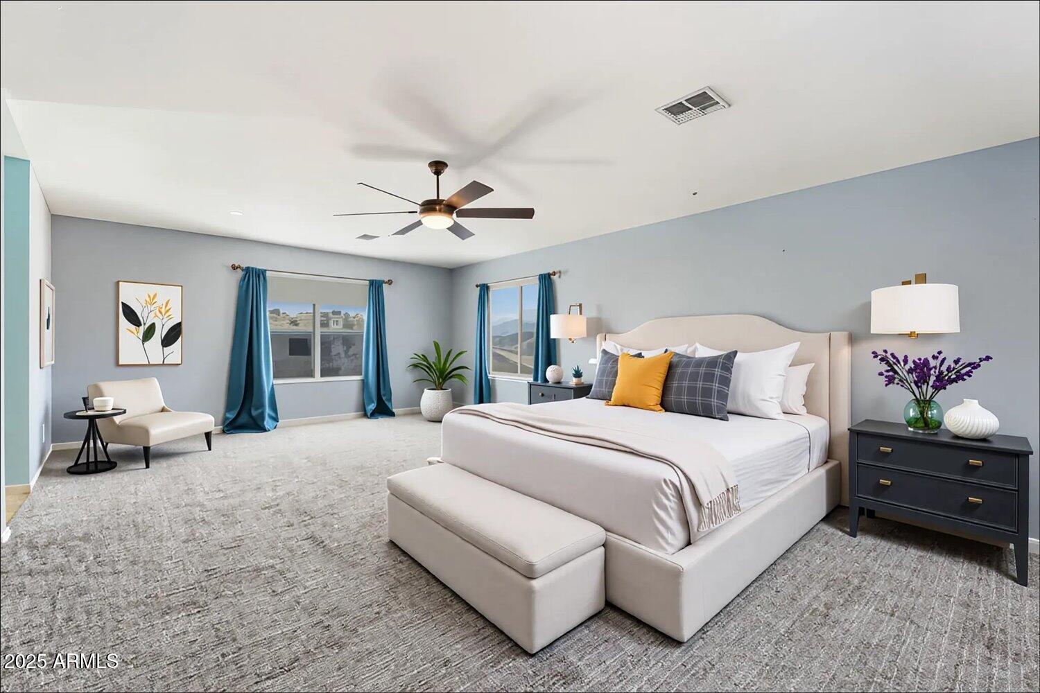 12745 West Calavar Road El Mirage, AZ 85335 - Photo 6 of 56 a spacious bedroom with a bed and ceiling fan