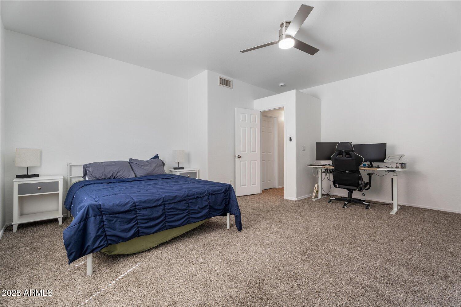 12745 West Calavar Road El Mirage, AZ 85335 - Photo 23 of 56 a bed room with a bed and furniture