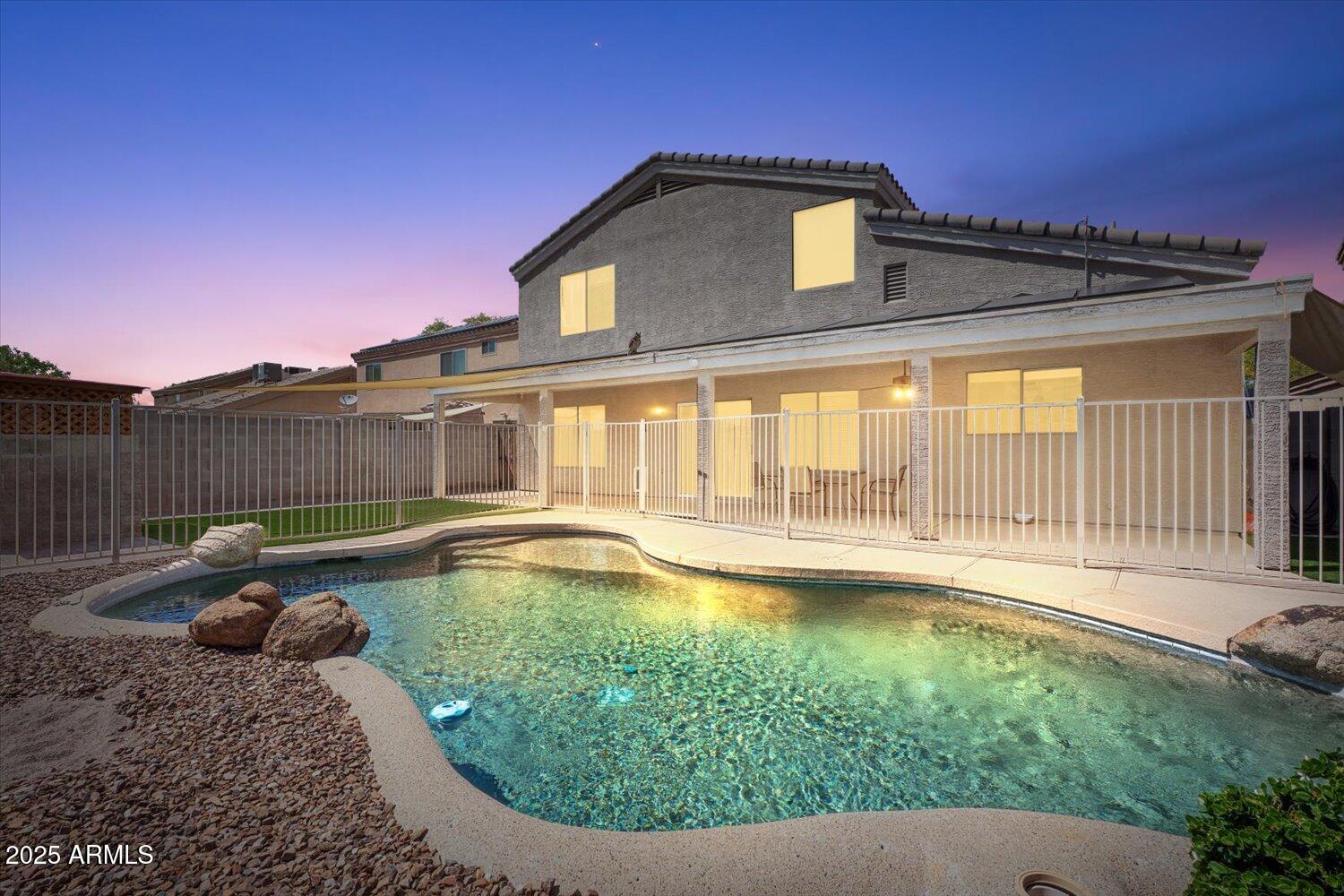 12745 West Calavar Road El Mirage, AZ 85335 - Photo 2 of 56 a view of a house with pool and a yard