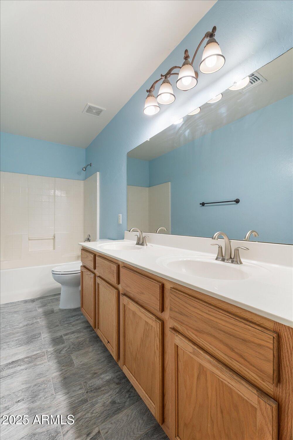 12745 West Calavar Road El Mirage, AZ 85335 - Photo 34 of 56 a spacious bathroom with a double vanity sink mirror and toilet