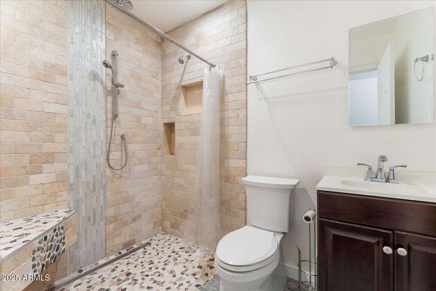 12745 West Calavar Road El Mirage, AZ 85335 - Photo 44 of 56 a bathroom with a sink a toilet and shower