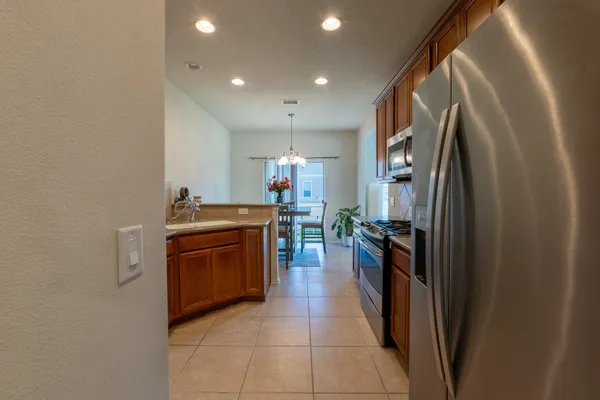 a kitchen with stainless steel appliances granite countertop a refrigerator and a stove
