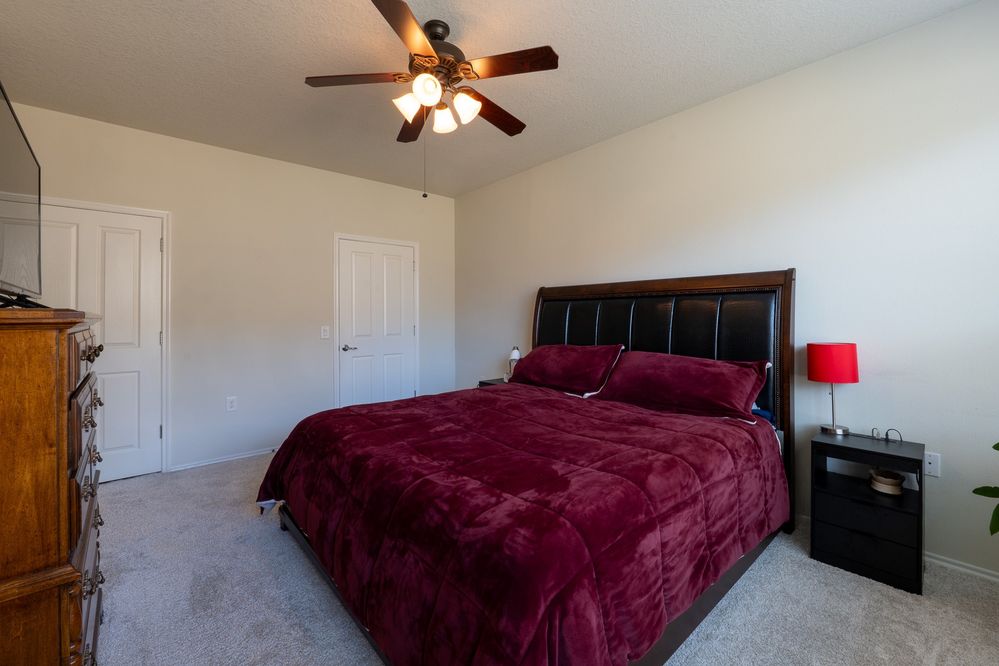 13600 Breton Ridge Street, Unit 29F Houston, TX 77070 - Photo 17 of 21 The bedroom features a spacious layout with a plush bed, neutral walls, and soft carpeting. It includes a ceiling fan, ample natural light, and a cozy atmosphere.