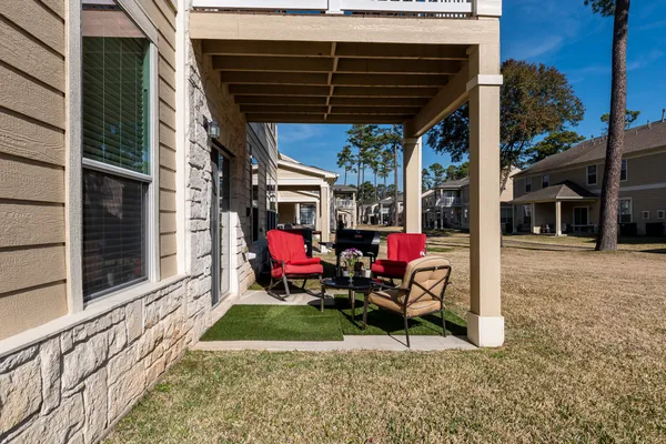 a view of yard with wooden roof and outdoor seating