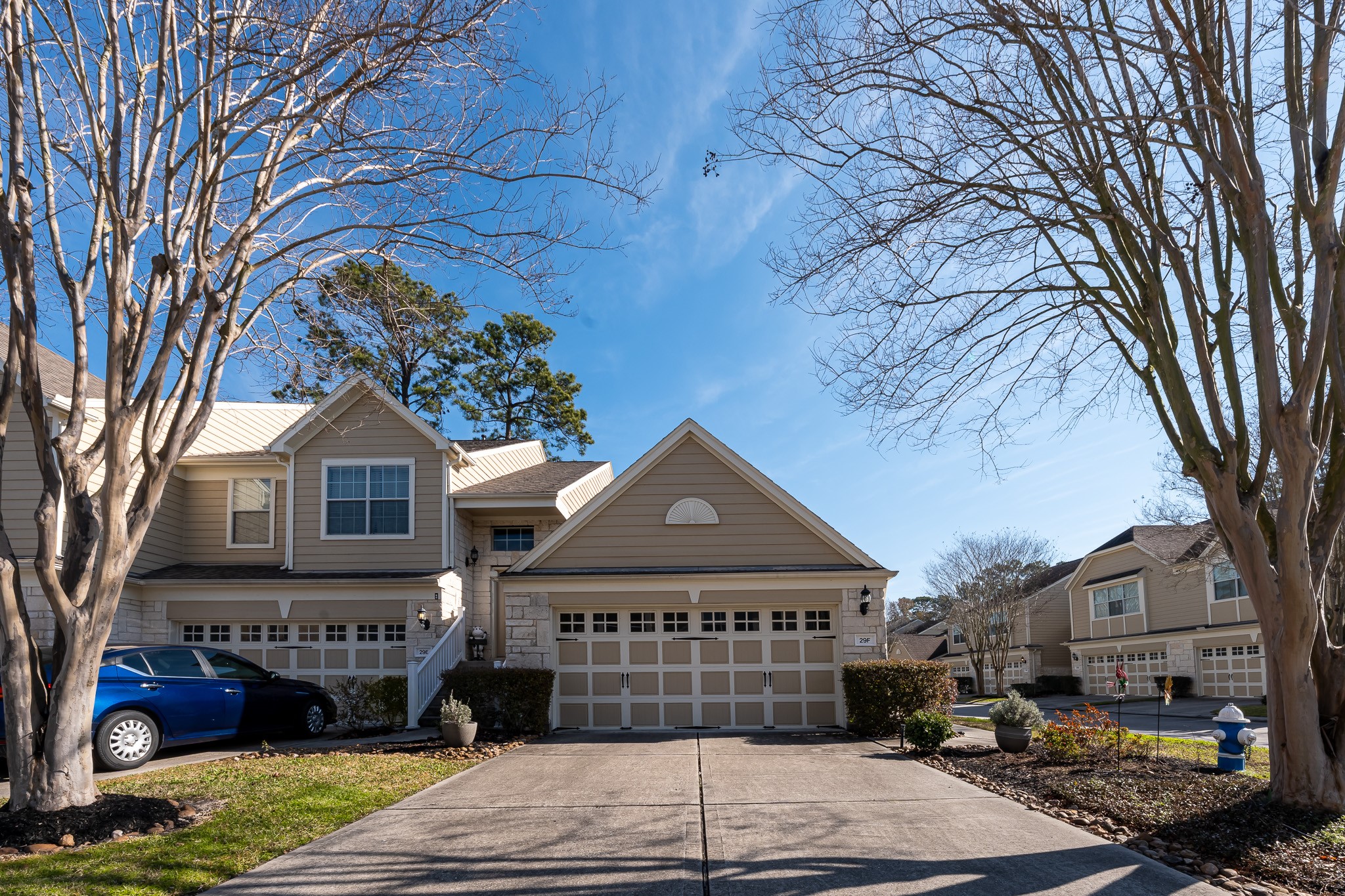 13600 Breton Ridge Street, Unit 29F Houston, TX 77070 - Photo 2 of 21 Charming townhome with a two-car garage, set in a serene neighborhood. The exterior features a well-maintained lawn and mature trees, providing a welcoming entrance. Perfect for families seeking a cozy, community-oriented setting.