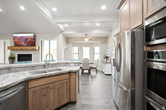 175 West 1000 North Mapleton, UT 84664 - Photo 11 of 42 Open-concept kitchen with wood-finish flooring, stainless steel appliances, and a double basin sink