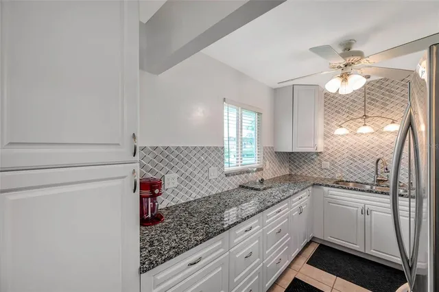 a kitchen with a sink a stove and cabinets