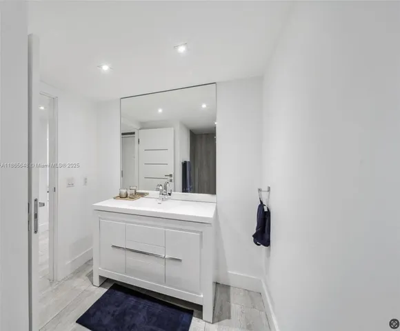 a bathroom with a sink a toilet and mirror