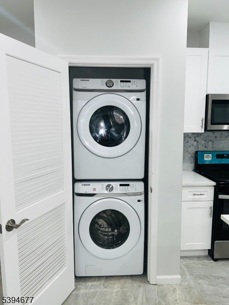 67 Wainwright Street, Unit 1 Newark, NJ 07112 - Photo 3 of 9 a utility room with dryer and washer